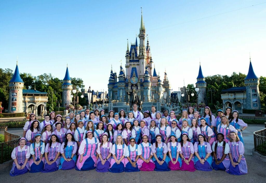 The Bibbidi Bobbidi Boutique Cast outside Cinderella Castle pictured ahead of their reopening. Image © Disney 