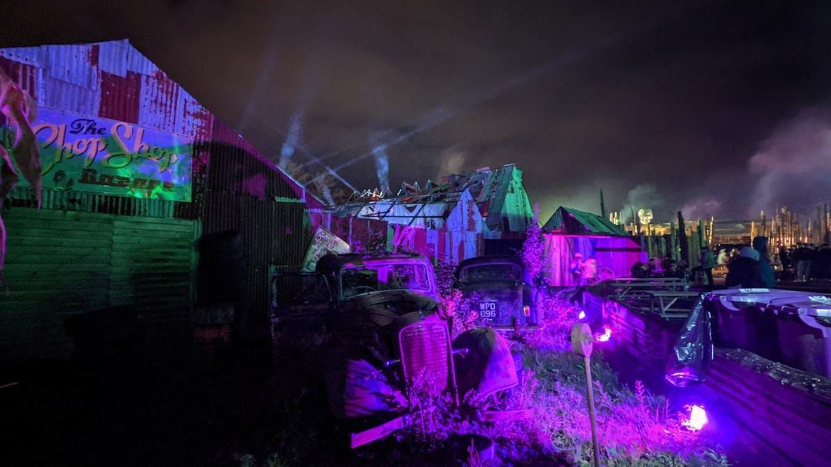 Chop Shop haunt lit up at night with Wateslands Penitentiary in the background