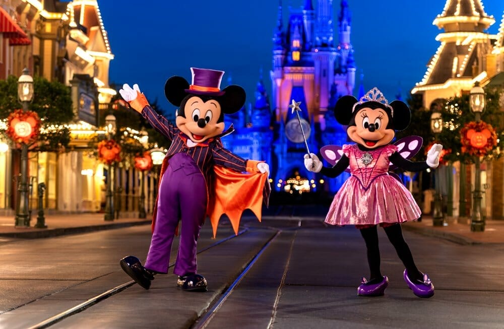 Mickey And Minnie dressed in their halloween best in main Street USA