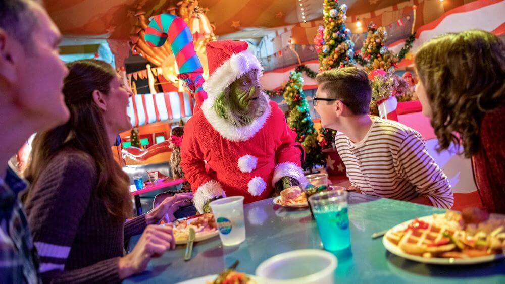 The Ginch meeting a family seated for breakfast at Universal Orlando