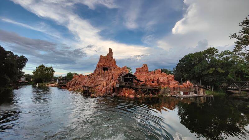 Looking back at Big Thunder Mountain from Liberty Belle Riverboat as storm clouds rise overhead
