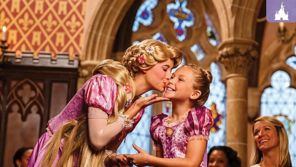 A disney Princess kissing a visitor on the cheek in Cinderella's Royal Table prior to the COVID shutdown
