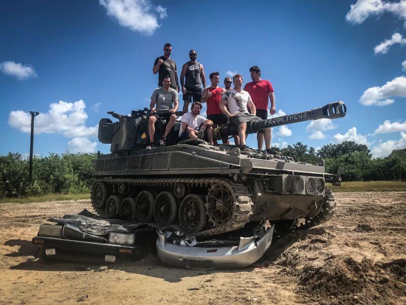 People standing on one of the tanks in Tank America near DOwntown Orlando