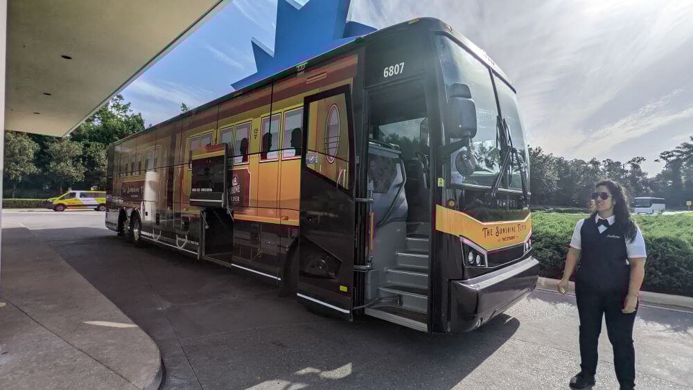 A Sunshine Flyer bus with conductor waiting outside Pop Century Resort in August 2022