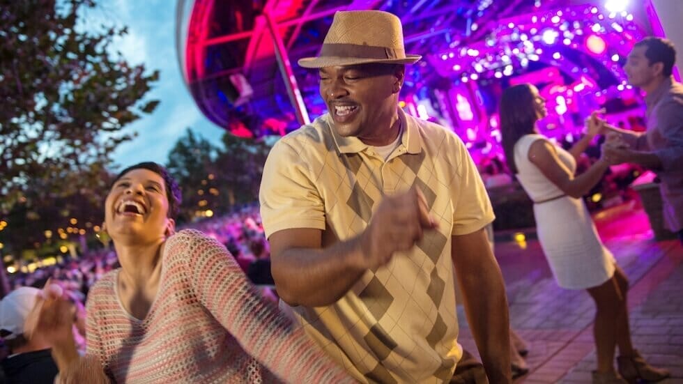 Visitors smiling and dancing in front of the Garden Rocks stage at EPCOT