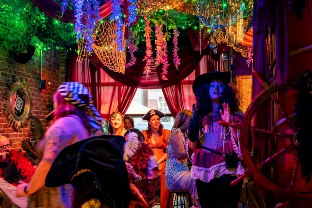 Actors and guests interacting in a room decorated to look like Neverland during the 90-minute experience