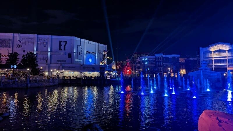 Water fountains lit up in the Universal Studios lagoon after a performance of Cinematic Celebration in 2022.