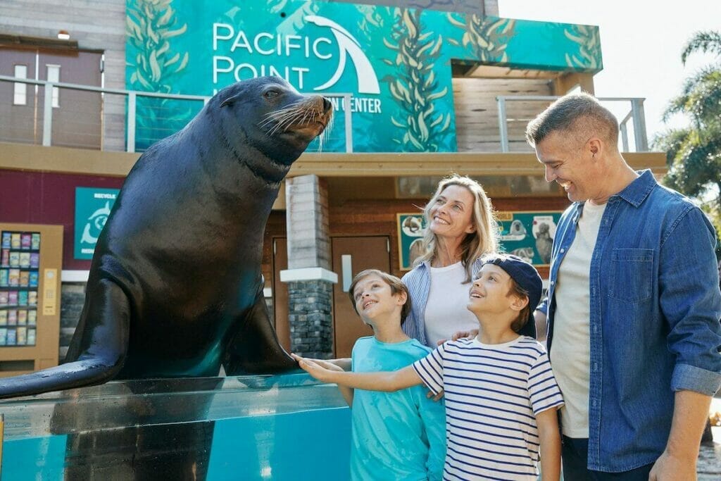 A family enjoying a close up encounter with Clyde the sealion and the Sealion & Otter Stadium