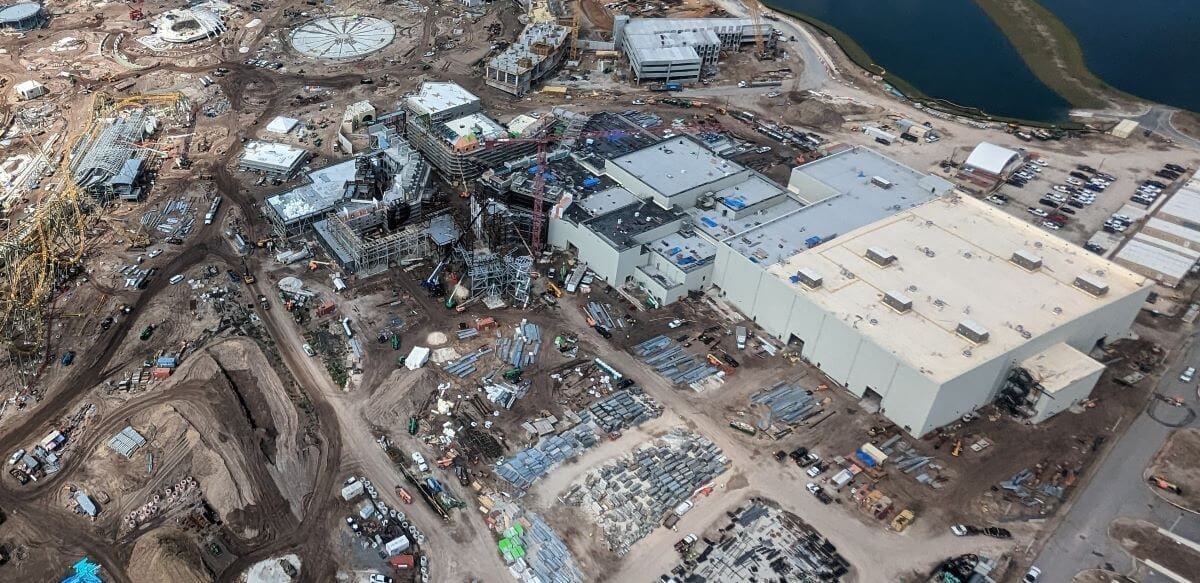 Aerial view over Epic Universe's Wizarding World Ministry Of Magic Area under construction. Hotspots expand on the land's attractions and experiences.