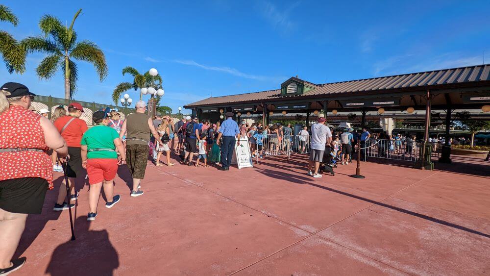 A queu of people waiting to enter Animal Kingdom on a bright sunny morning