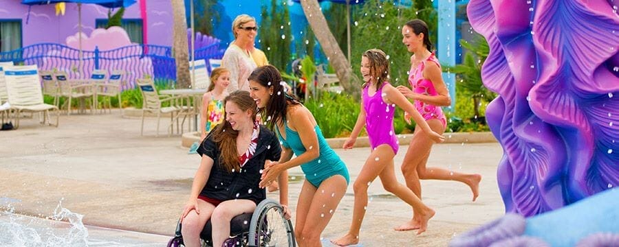 A disabled mum enjoying splash facilities at a Disney World hotel. Image © Disney.