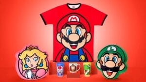 Super Nintendo World merchandise promo photo showing a red Mario t-shirt and character mugs.