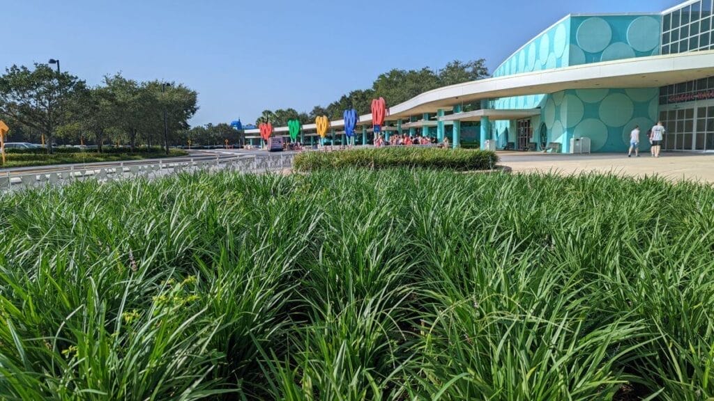 Looking at the entrance of the Pop Century Resort with Luggage Services on the right hand side.